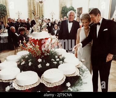 File photo - EXCLUSIVE. Late U.S. President Ronald Reagan and his wife Nancy admire a cake prepared by former White House Pastry Chef, Frenchman Roland Mesnier, for Reagan's 70th birthday party at the White House in Washington DC, USA. Roland Mesnier, the French-born White House pastry chef who produced delicacies for five US presidents, has died at the age of 78. Mesnier was first hired during Jimmy Carter's presidency in 1979 and retired in 2004 under George W Bush. He died on Friday 'following a short illness', the White House Historical Association said on its website. Mesnier famously wro Stock Photo