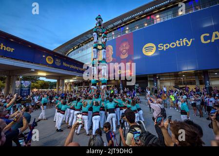 Castellers de Vilafranca (human towers, a catalan tradition) outside the Spotify Camp Nou at twilight on a match day (Barcelona, Catalonia, Spain) Stock Photo