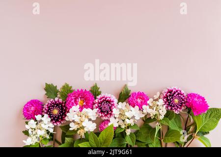 autumn flower arrangement. border of asters, dahlias and hydrangeas. top view. beige background. space for text Stock Photo