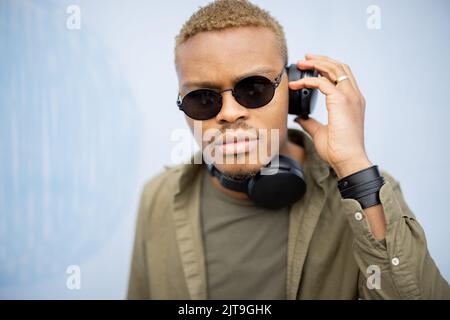 Man listen music in earphones and use smartphone Stock Photo