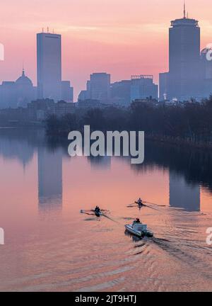 A vertical shot of the rowers along the Charles river at sunrise with the Boston skyline, USA Stock Photo