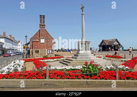 Vivid red Geraniums at War Memorial in Aldeburgh & historical 16th-century chimney Moot Hall now a local history museum Suffolk East Anglia England UK Stock Photo