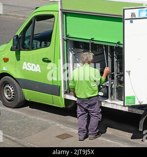 Aerial side view looking down on green Asda supermarket home shopping delivery van driver sorting pre ordered online grocery food  Essex England UK Stock Photo