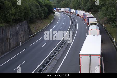 stack of trucks in a long traffic jam on the freeway at night Stock ...