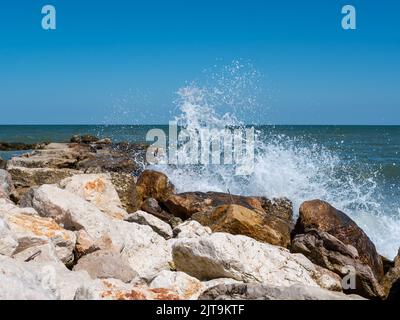 Waves break on rocks in the Adriatic Sea Italy Stock Photo