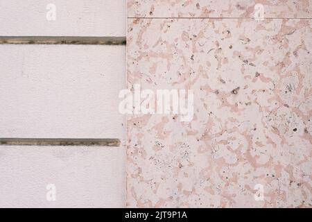 Decorative marble stone tile wall, texture, dirty and aged building facade surface, outside architecture decoration details, background. Stock Photo