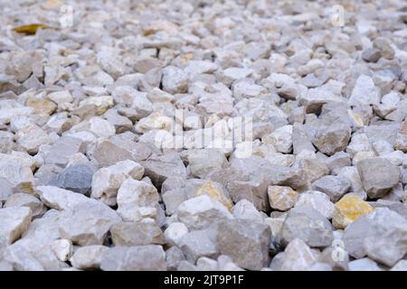 Close up of small white marble stones background, a pile of rocks, natural texture, crushed decorative gravel. Stock Photo