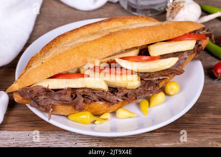 Doner kebab between bread. Meat doner kebab on wooden background. Traditional Turkish cuisine. close up Stock Photo