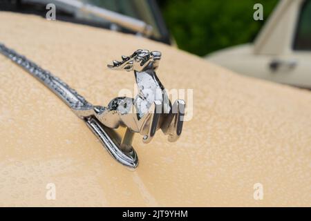 Figurine of deer on the hood of GAZ M21 Volga at Classic Soviet Car Exhibition Stock Photo