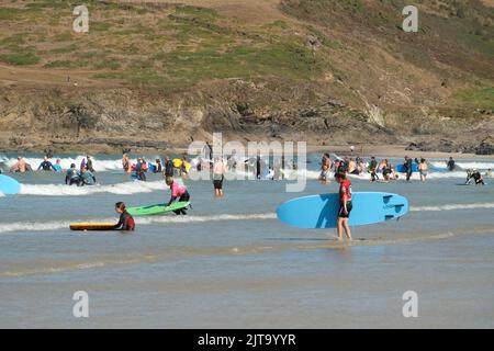Polzeath, Cornwall, UK. 29th August 2022. UK Weather. Bank holiday monday brought the best weather of the weekend for visitors to Polzeath beach in Cornwall. Credit Simon Maycock / Alamy Live News Stock Photo