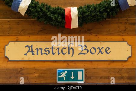Munich, Germany. 29th Aug, 2022. A sign reading "Anstich Boxe" hangs above an emergency exit sign in a beer tent on the Wiesn grounds. The Oktoberfest is scheduled to take place this year from 17.09.2022 to 03.10.2022. Credit: Peter Kneffel/dpa/Ģ����ý Live News Stock Photo
