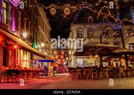 MAASTRICHT, THE NETHERLANDS - NOVEMBER 22, 2016: Bars and restaurants with christmas lights on the Sint Amorsplein square in Maastricht, The Netherlan Stock Photo