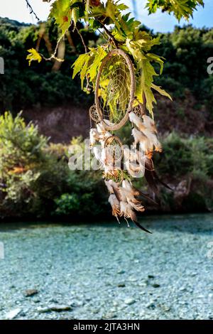 dream catcher hanging on a tree, next to the river Acheron Stock Photo