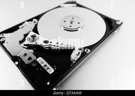 Computer hard drive with top cover removed. Disassembled HDD of a personal computer. Selective Focus Stock Photo