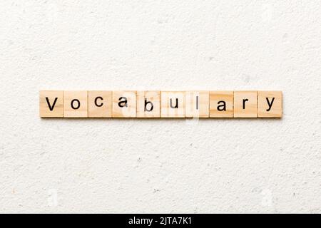vocabulary word written on wood block. vocabulary text on table, concept. Stock Photo