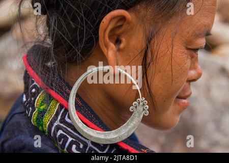 Vietnam, Sapa region. Portrait of a Hmong woman with an traditional earring.The hill tribe Hmong is taking care of most of the tourists that visit the Stock Photo
