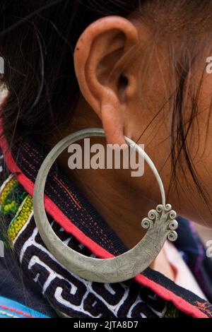 Vietnam, Sapa region.Portrait of a Hmong woman with an traditional earring.The hill tribe Hmong is taking care of most of the tourists that visit the Stock Photo