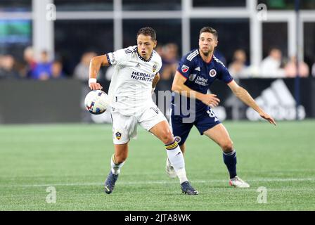 Foxborough, USA. 28th Aug, 2022. August 28, 2022; Foxborough, MA, USA; Los Angeles Galaxy forward Javier Hern‡ndez (14) and New England Revolution midfielder Matt Polster (8) in action during an MLS match between L.A. Galaxy and New England Revolution at Gillette Stadium. Anthony Nesmith/CSM Credit: Cal Sport Media/Alamy Live News Stock Photo