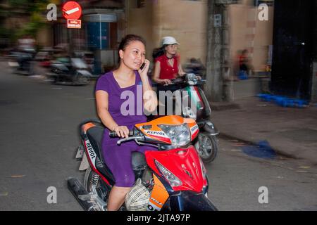 Vietnam, Hanoi Using the mobile phone while driving is a common habit by most people. Stock Photo