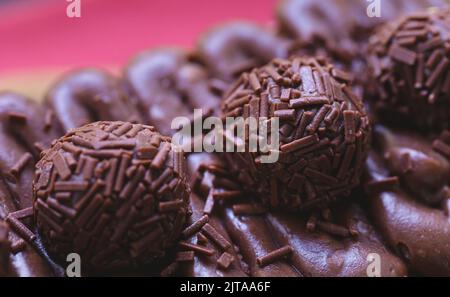 Cake called Brigadeiro Caseirinho. Chocolate cake with chocolate frosting and brigadiers to decorate. Confectionery, dessert. Stock Photo