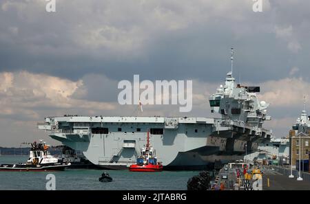 Portsmouth, UK. August 27th 2022. Aircraft Carrier HMS Prince of Wales seen being prepared leaving the harbour. Stock Photo