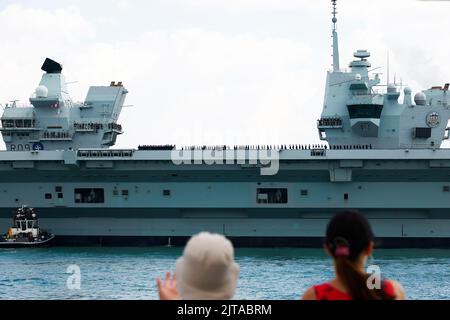 Portsmouth, UK. August 27th 2022. Aircraft Carrier HMS Prince of Wales watched by people when preparing to  leave the harbour. Credit: Joe Kuis / Alamy Reportage Stock Photo