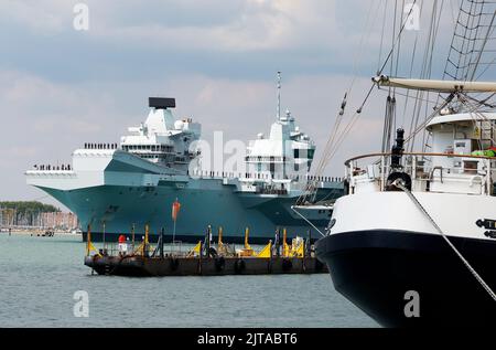 Portsmouth, UK. August 27th 2022. Aircraft Carrier HMS Prince of Wales seen leaving the harbour. Credit: Joe Kuis / Alamy Reportage Stock Photo