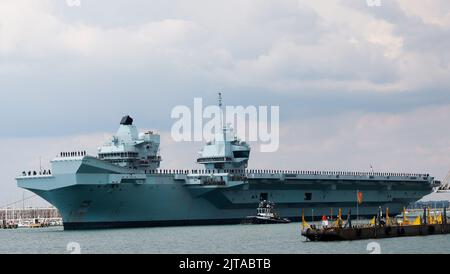 Portsmouth, UK. August 27th 2022. Aircraft Carrier HMS Prince of Wales seen leaving the harbour. Credit: Joe Kuis / Alamy Reportage Stock Photo