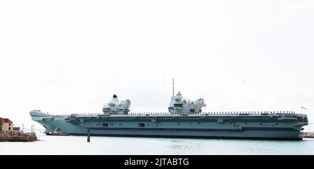 Portsmouth, UK. August 27th 2022. Aircraft Carrier HMS Prince of Wales seen leaving the harbour. Credit: Joe Kuis / Alamy Reportage Stock Photo