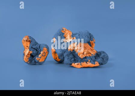 Minimalist Blue Toned Background With Natural Sea Stones Decorated With Gold. Good for product display. Stock Photo
