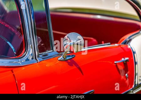 Statesboro, GA - May 17, 2014: Shallow depth of field closeup of the driver rearview mirror and vent window detail on a 1955 Chevrolet BelAir. Stock Photo