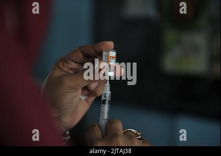 Sylhet, Mexico City, Bangladesh. 28th Aug, 2022. 28 August 2022, Sylhet, Bangladesh: A health worker prepares a Comirnaty dose during a vaccination program to children against increase infection of Covid-19 disease. (Credit Image: © Md Rafayat Haque Khan/eyepix via ZUMA Press Wire) Stock Photo