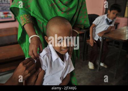 Sylhet, Mexico City, Bangladesh. 28th Aug, 2022. 28 August 2022, Sylhet, Bangladesh: A child from Kanishail Primany school receives a Comirnaty dose during a vaccination program to children against increase infection of Covid-19 disease. (Credit Image: © Md Rafayat Haque Khan/eyepix via ZUMA Press Wire) Stock Photo