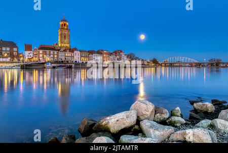 The city of Deventer is a historic and well known city in the Netherlands. Here we see it during blue hour under a full moon. Stock Photo