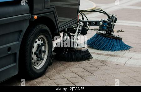 sweeper is sweeping asphalt. Cleaning the path with a cleaning vehicle Stock Photo