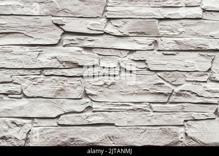 Texture of a wall covered with decorative brick-like tiles. Abstract background for design. Stock Photo