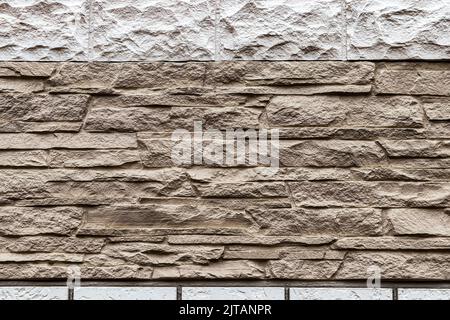 Texture of a wall covered with decorative brick-like tiles. Abstract background for design. Stock Photo