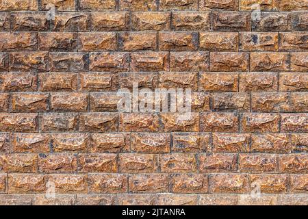 Texture of a wall covered with decorative brick-like tiles. Abstract background for design. Stock Photo