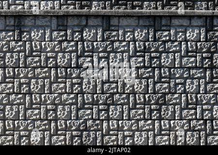 Texture of a wall covered with decorative brick-like tiles. Abstract background for design. Stock Photo