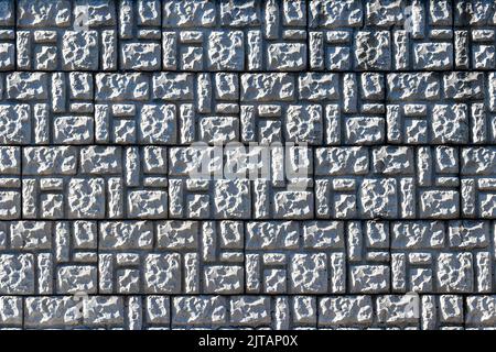 Texture of a wall covered with decorative brick-like tiles. Abstract background for design. Stock Photo