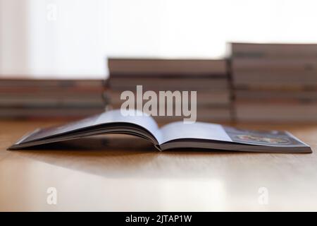 Open book on dining room table. Stock Photo