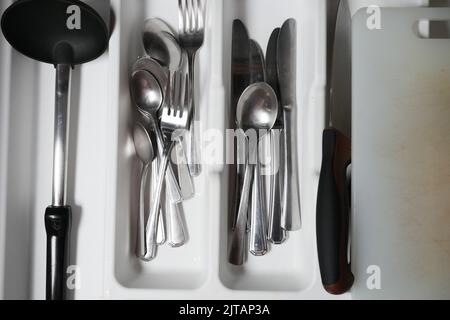 fork, knife and spoon on in a drawer top view  Stock Photo