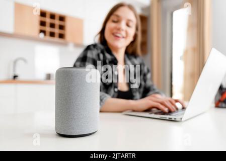 Woman using smart speaker, smart home concept Stock Photo