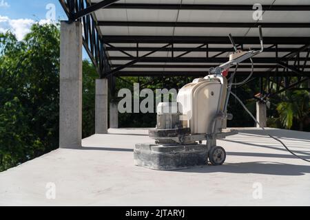 Concrete surface sanding machine, For workers use concrete sanding machine to smooth the cement floor. Stock Photo
