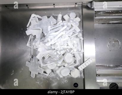 Detail objects printed on powder 3D printer and covered white polyamide powder close-up. Technology Multi Jet Fusion MJF. 3D prototype models created by new additive progressive 3d printing technology Stock Photo