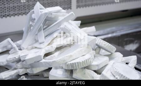 Detail objects printed on powder 3D printer and covered white polyamide powder close-up. Technology Multi Jet Fusion MJF. 3D prototype models created by new additive progressive 3d printing technology Stock Photo