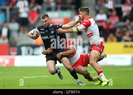 Wakefield Trinity's Max Jowitt (left) is tackled by St Helens' James Bell (centre) and Tom Makinson during the Betfred Super League match at the Totally Wicked Stadium, St Helens. Picture date: Monday August 29, 2022. Stock Photo