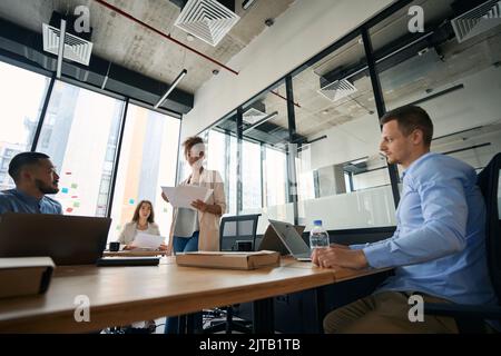 Portrait of meeting of young employees to discuss work issues Stock Photo
