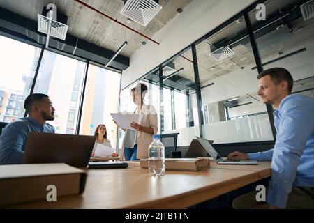 Photo of meeting of young colleagues to discuss work issues. Stock Photo