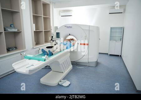 Man in the tomography room undergoes a diagnostic procedure Stock Photo